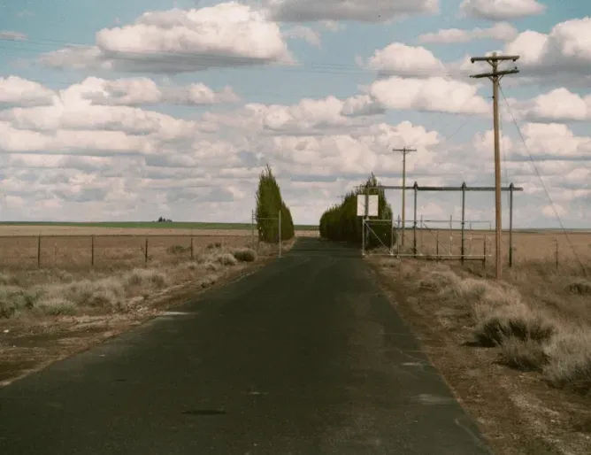 Access road leading to the missile base under a wide Washington sky